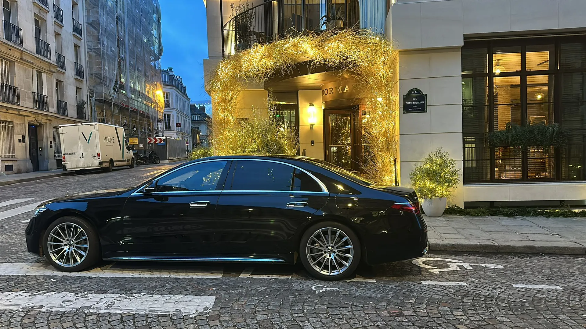 Luxury chauffeur-driven Mercedes at night